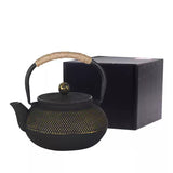 théière en fonte noire avec emballage