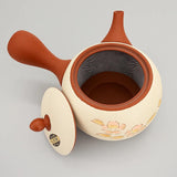 Théière Kyusu marron et blanche à fleurs de sakura, couvercle posé à côté et intérieur ouvert